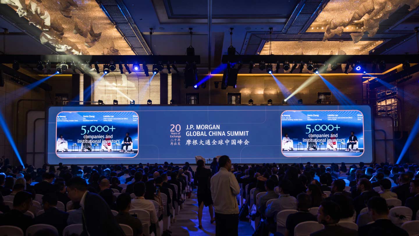 Presentation screen showing conference title, with 2 images on the side