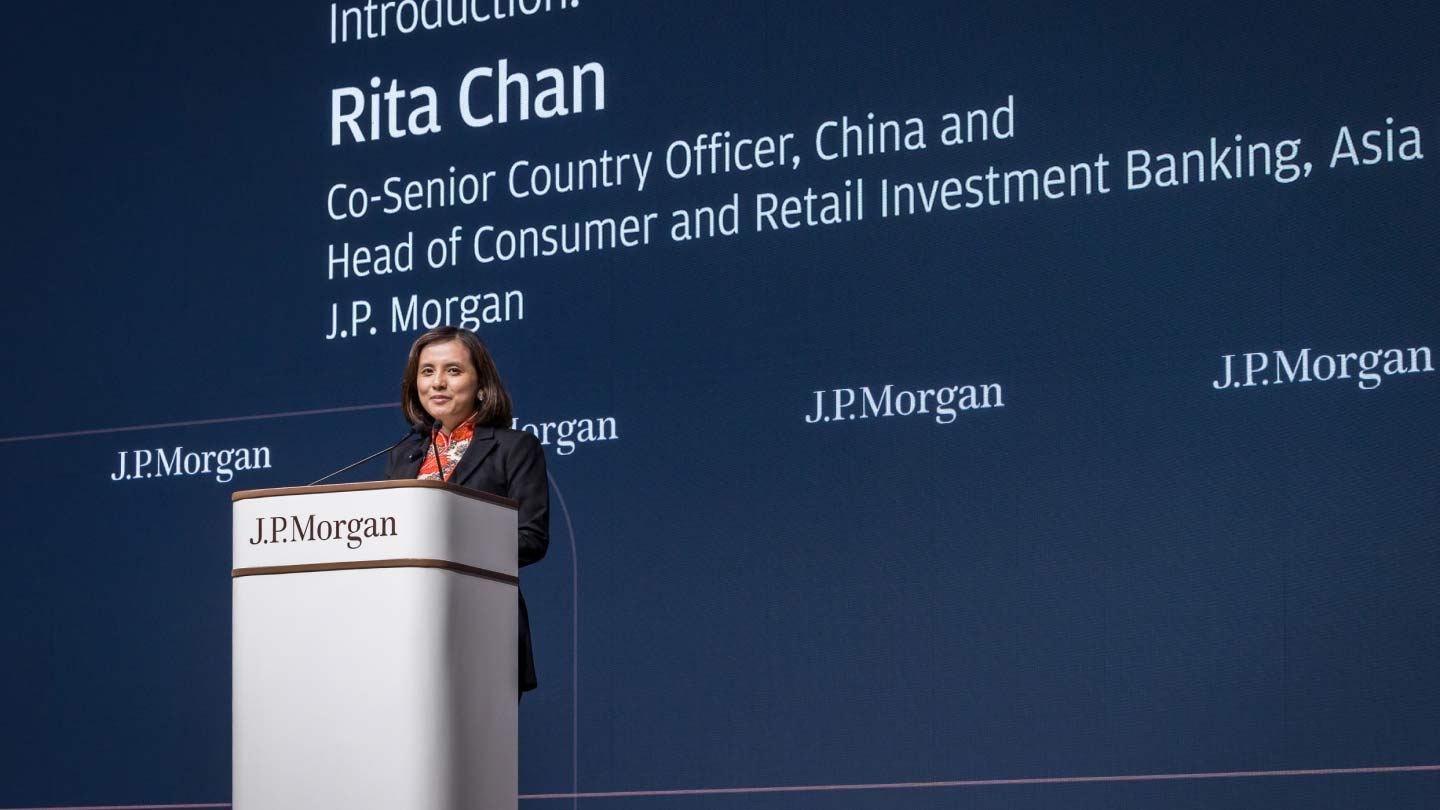 Rita Chan speaking at podium