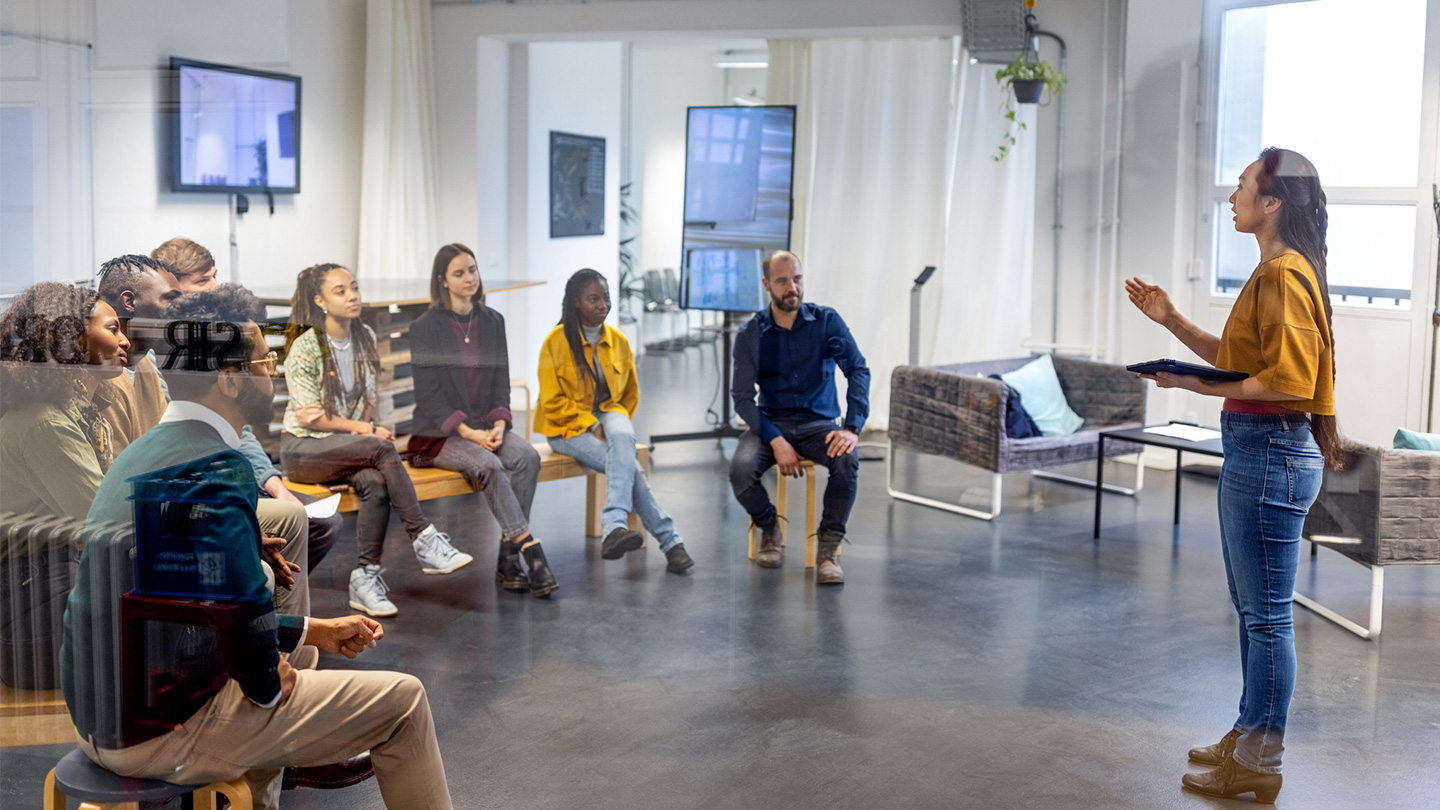 Person speaking to a seated crowd