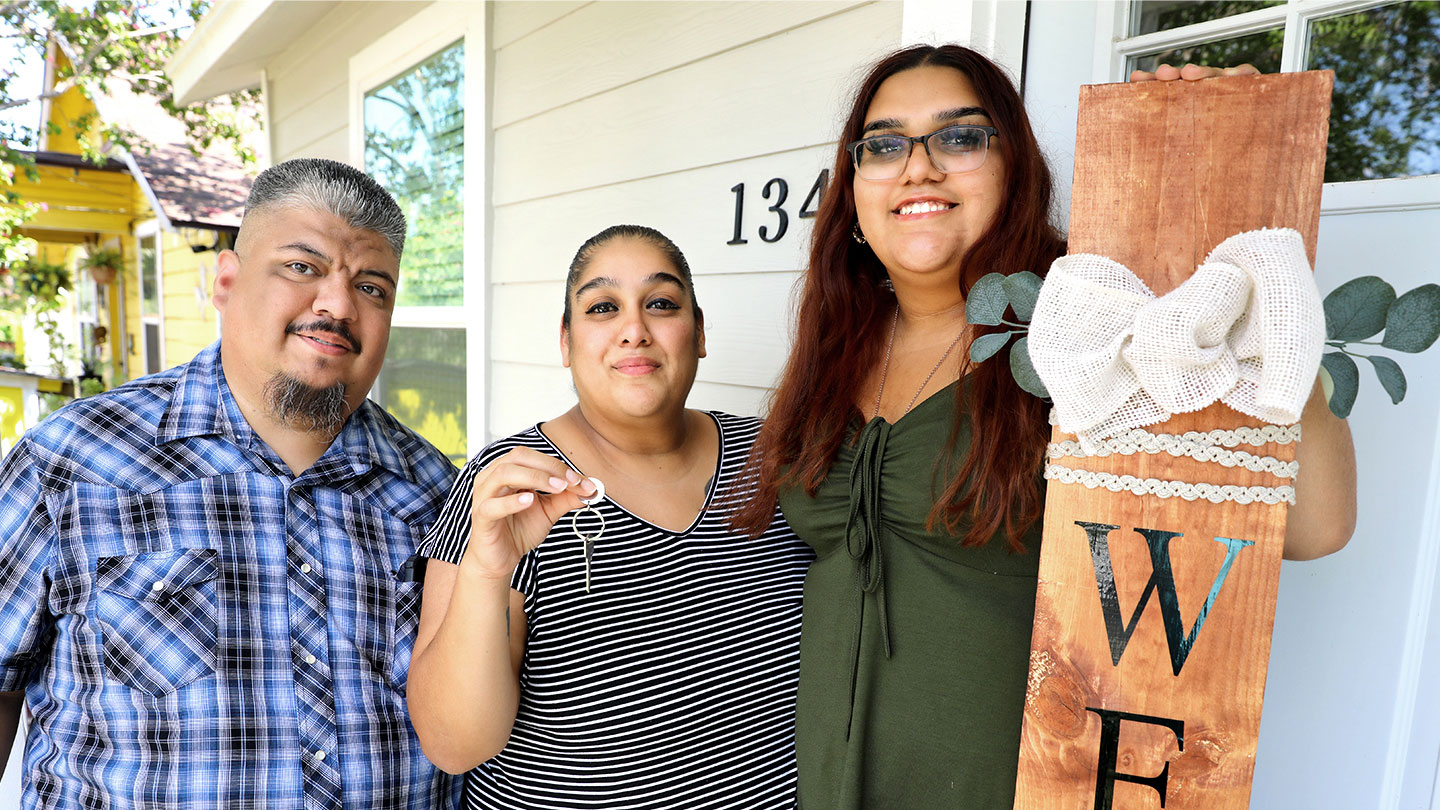 family in front of home