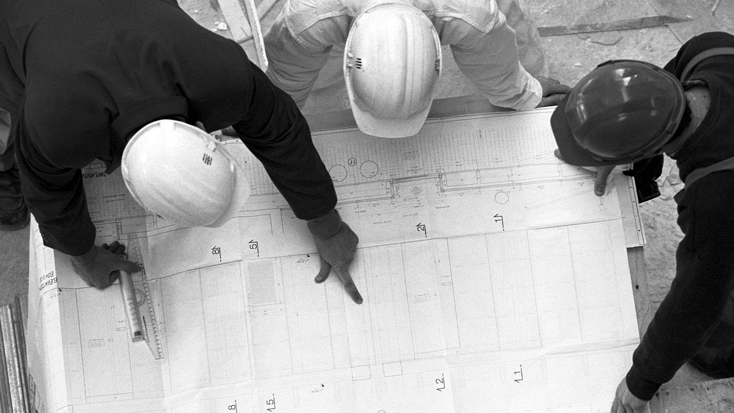 Construction workers looking at blueprint