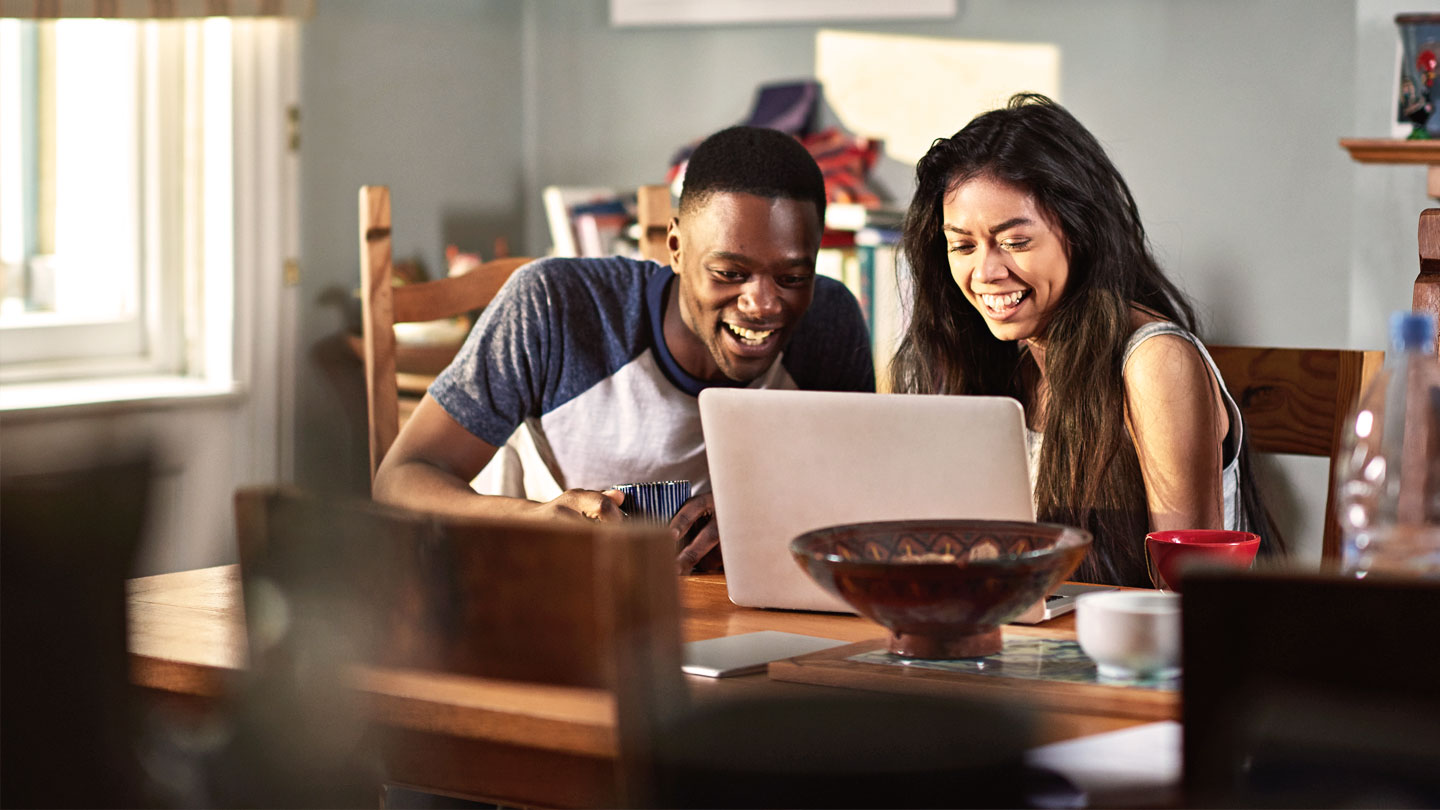 2 people sharing a laptop