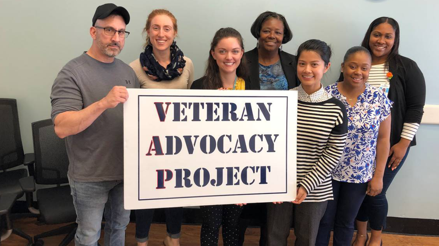 Goup of people holding a Veteran Adocacy Project poster