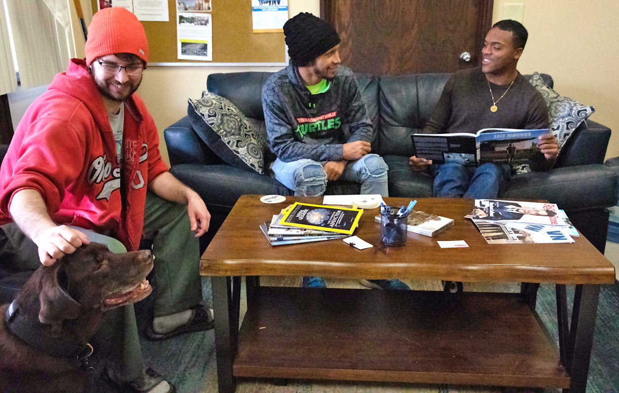 Three people sitting around a coffee table talking