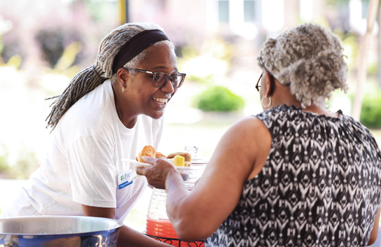 Winstead, who joined DHIC as President and CEO in June 2020, serves an attendee at a recent DHIC event. Winstead is the third leader in the organization’s nearly 50-year history. 