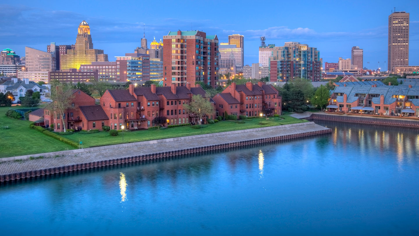 buildings in front of a river. 