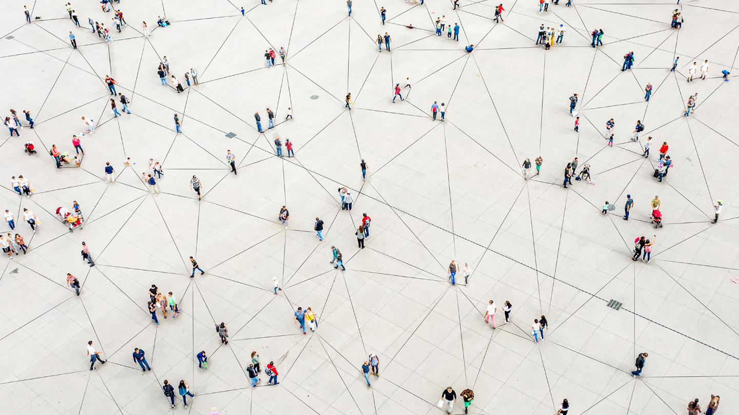 Aerial image of people standing and walking around concrete floor