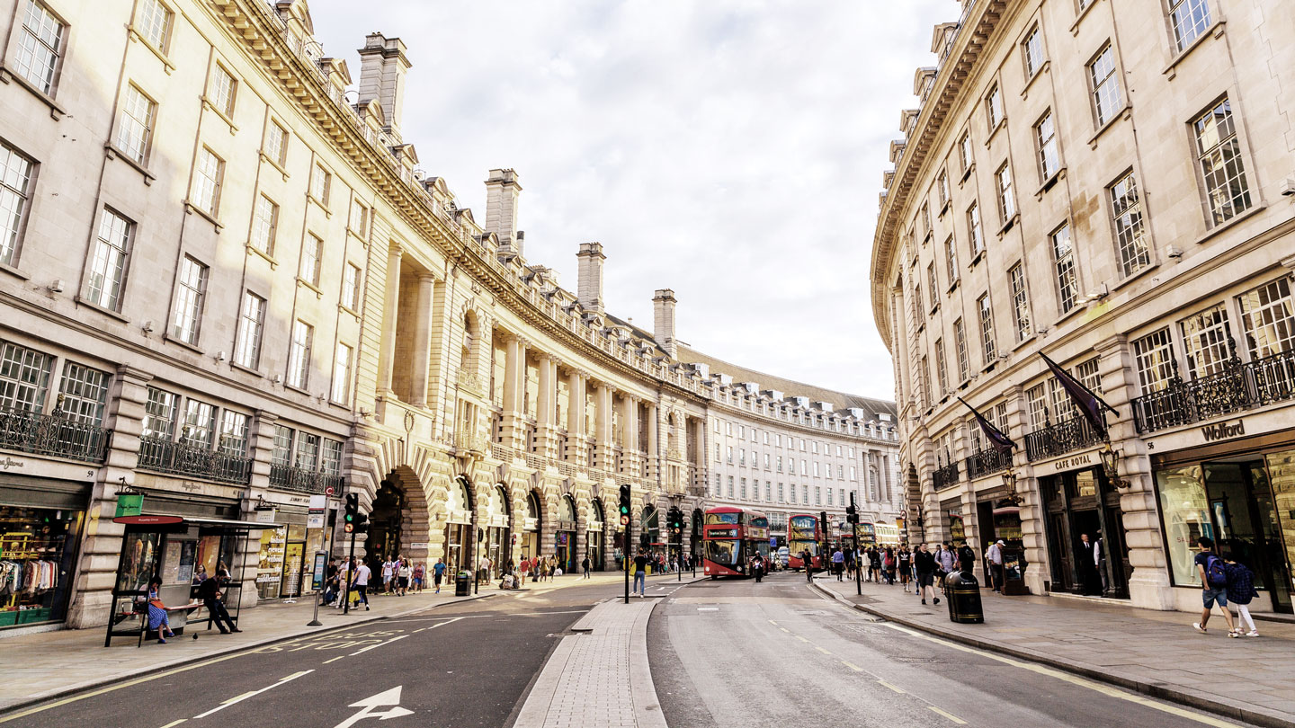 photo of view of city street with people walking