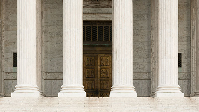 Large columns in front of a marble building