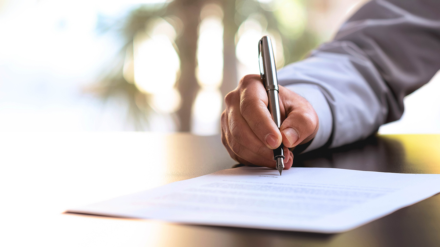 Businessman Signing An Official Document