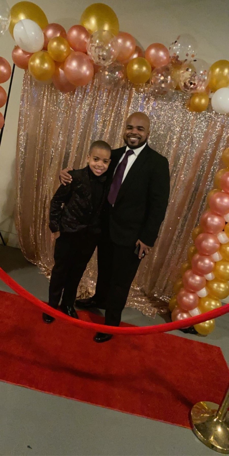 Ja’Shar Hartley in Suit with Son