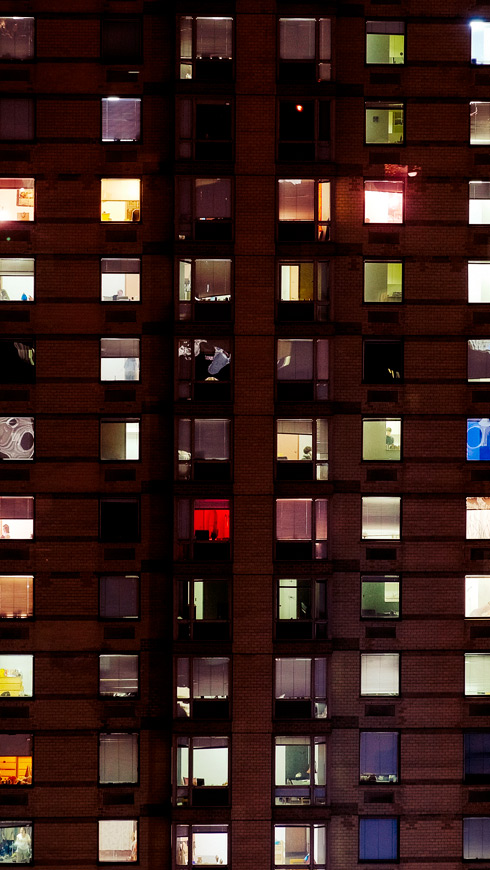 View of apartment complex windows at night