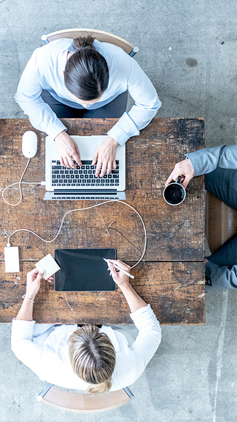 people by a table having a meeting