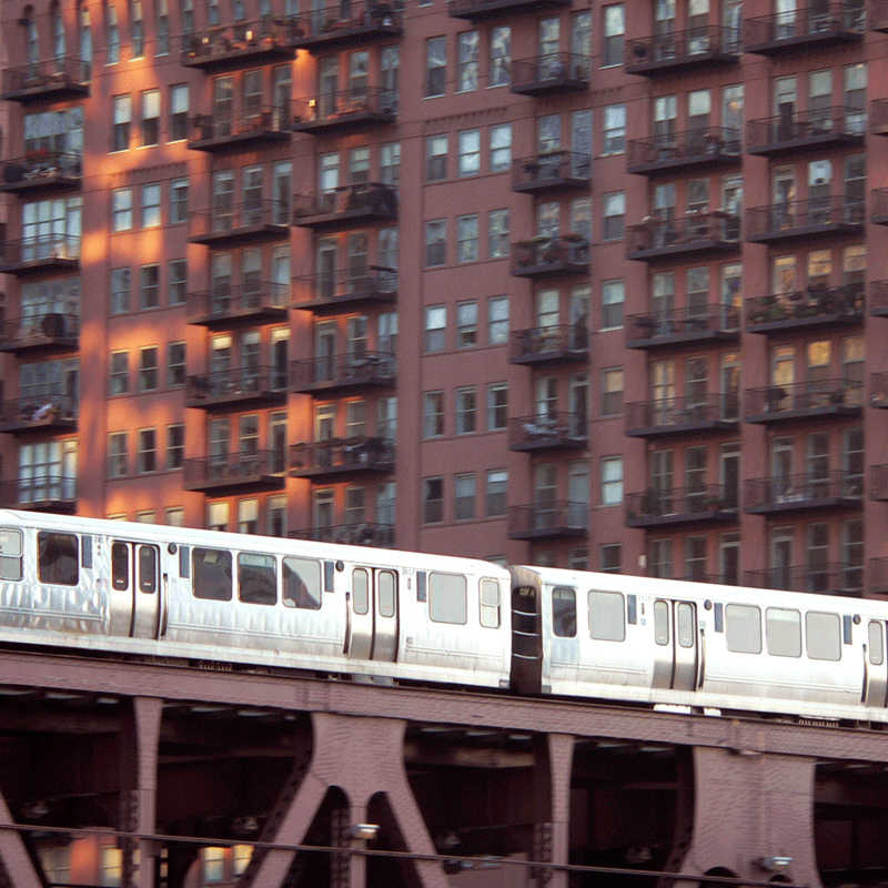 Train moving in front of apartment building