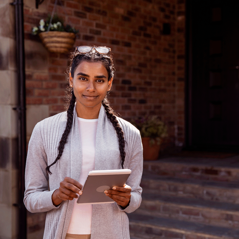 Woman grinning holding a tablet