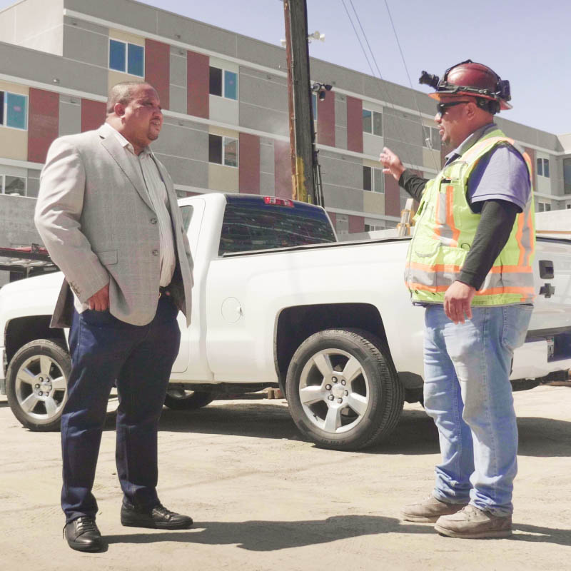 Men talking in front of construction site