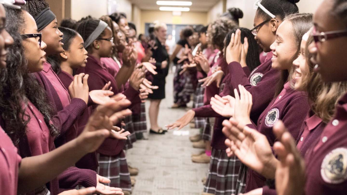 School girls clapping