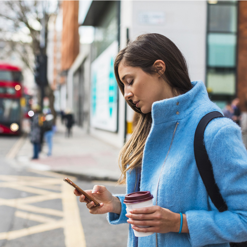 Woman on street looking at phone