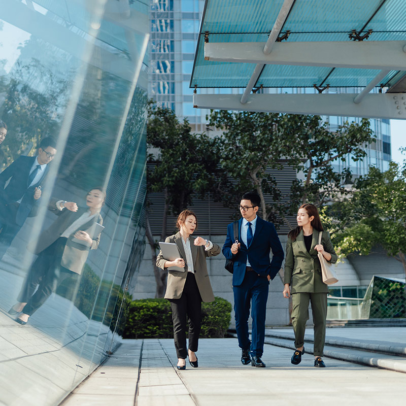 3 people walking to a meeting