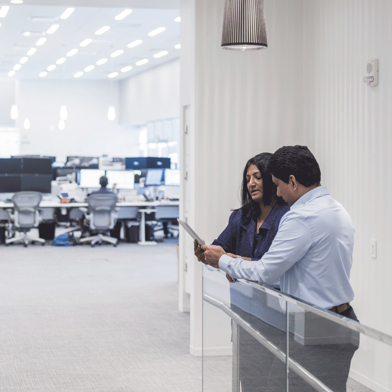 Two people consulting over a tablet