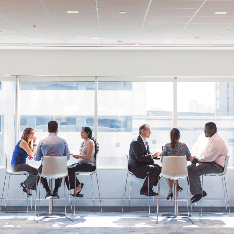 Group of people talking at two separate tables