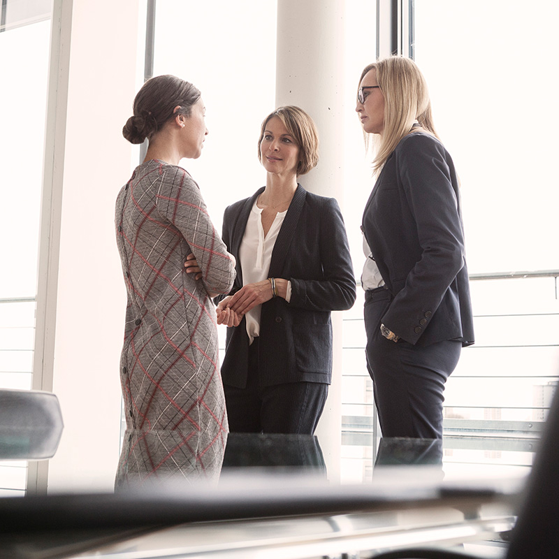 Professionals chatting in a work environment