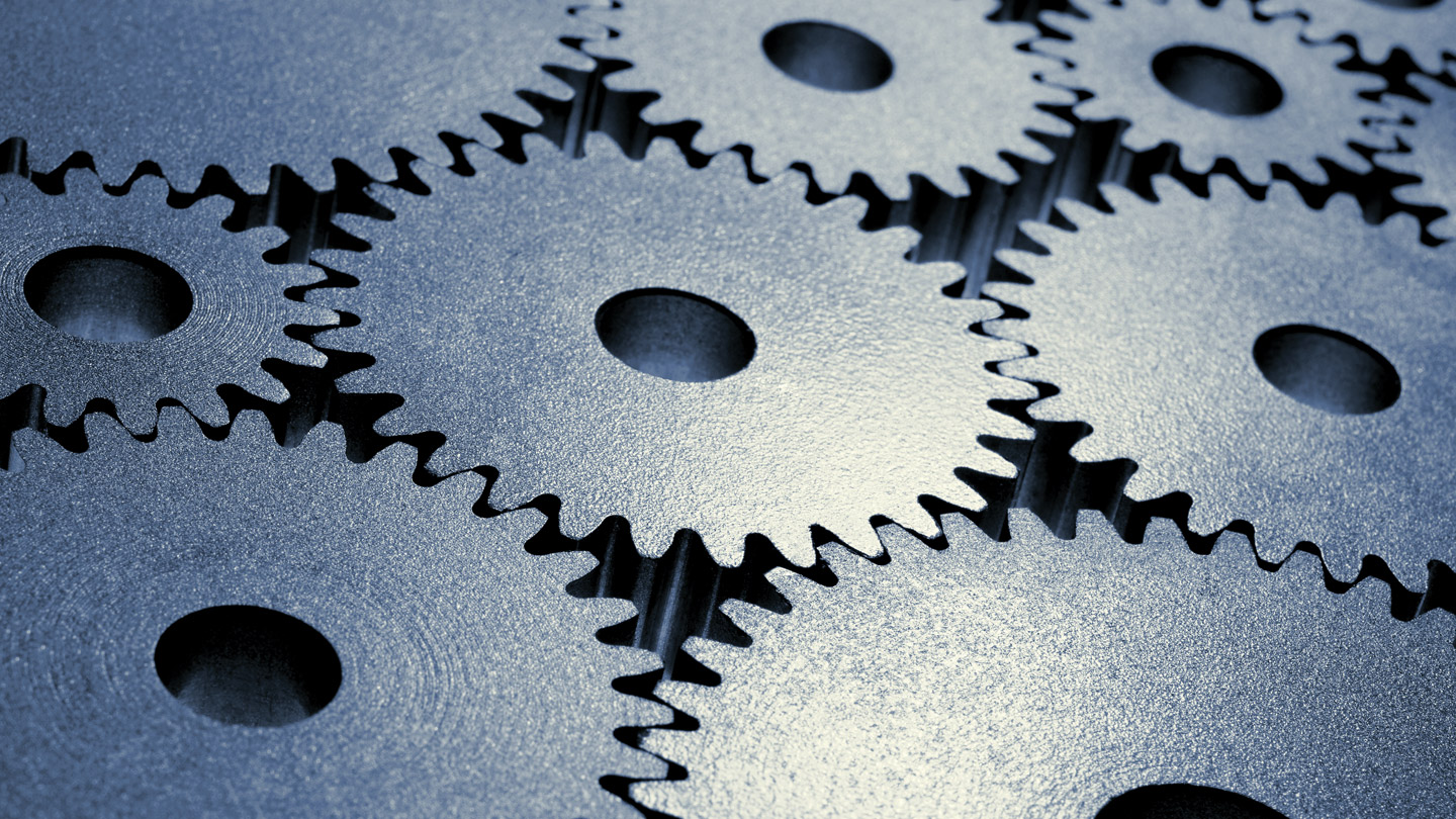 Abstract image of multiple grey gears next to each other
