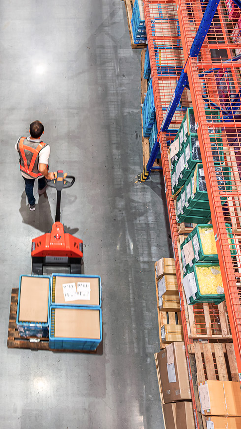 Man pulling dolly with packages