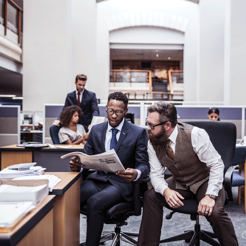 Two people looking at newspaper