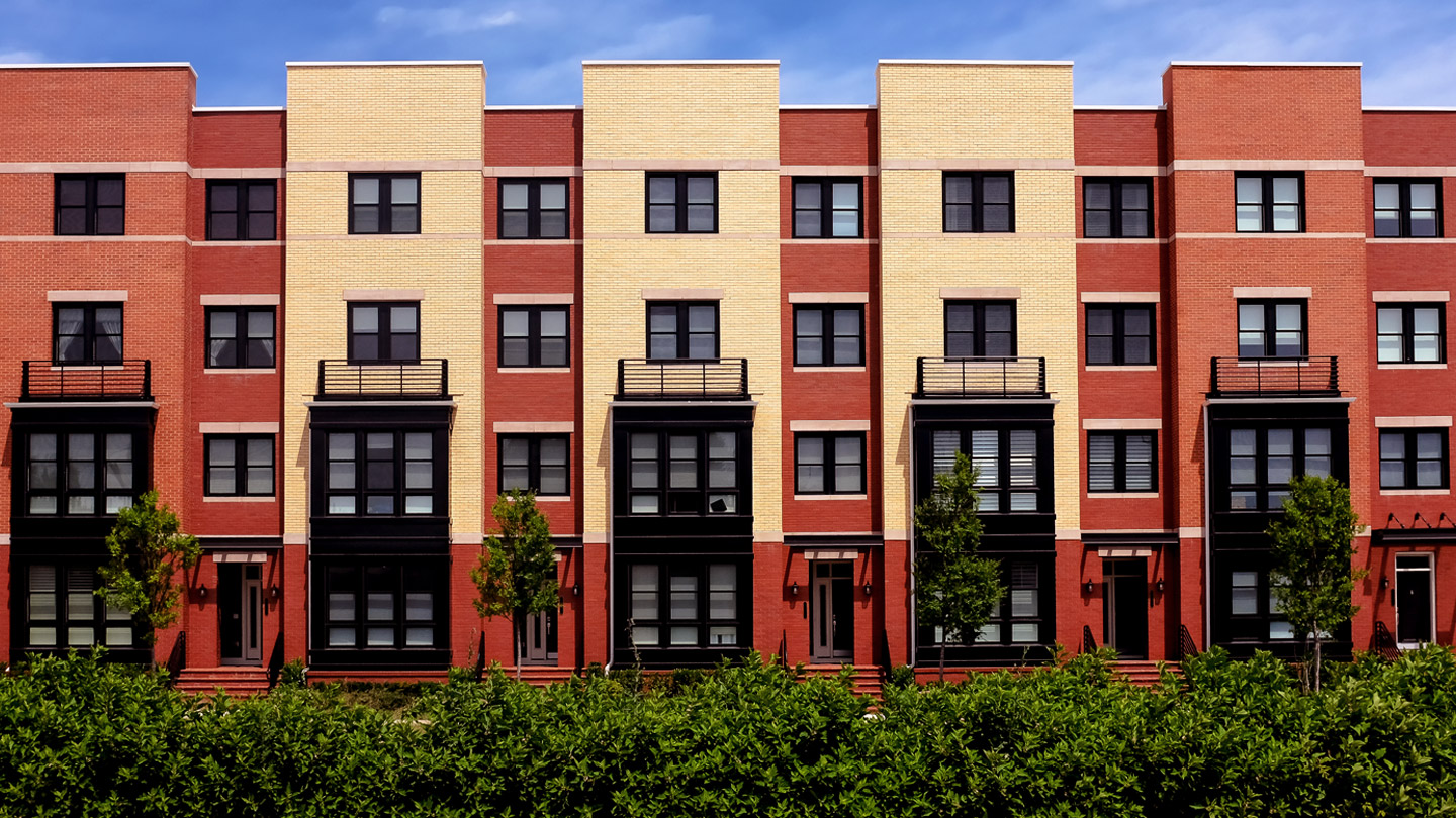 Red and yellow building with balconies