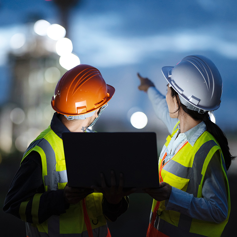 Engineers at computer outdoors