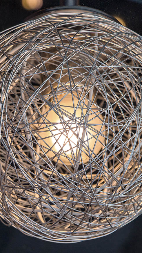 Abstract image of a light behind wire