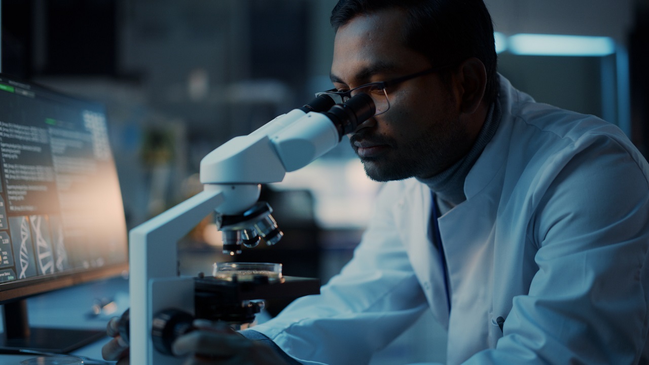 Man looking at microscope