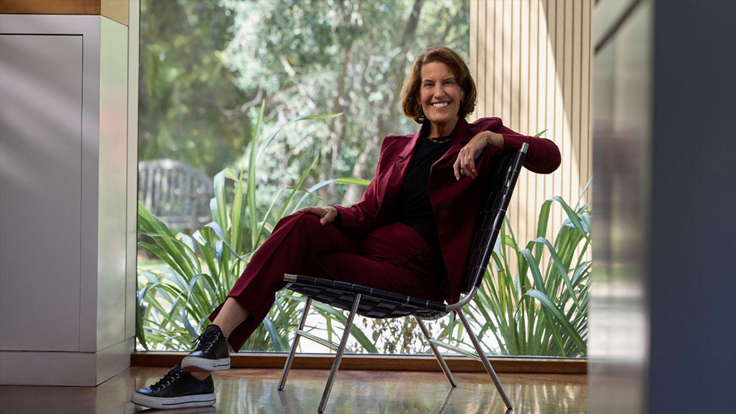 Founder of Midi sitting in a chair, smiling at camera