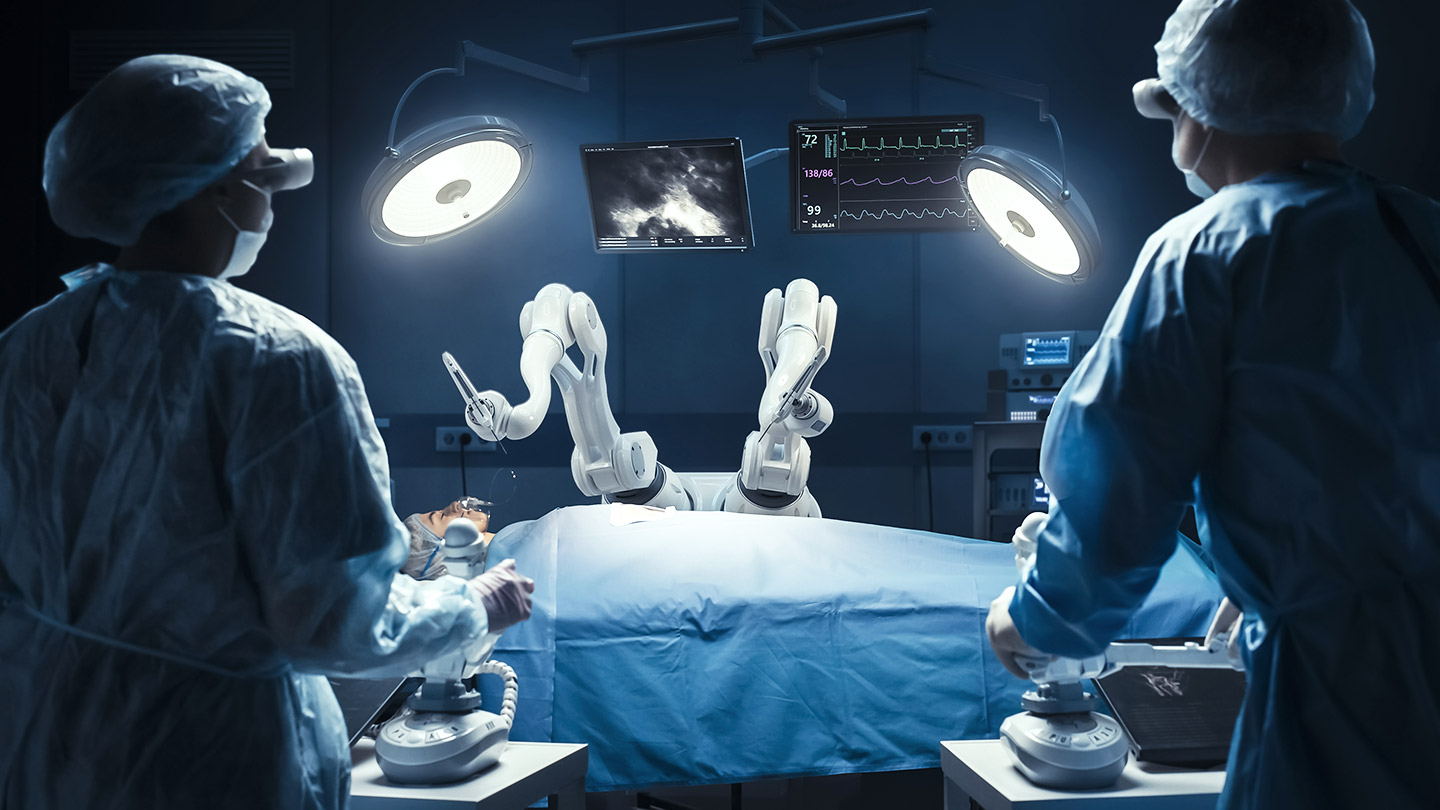2 surgeons watching a robot perform an operation