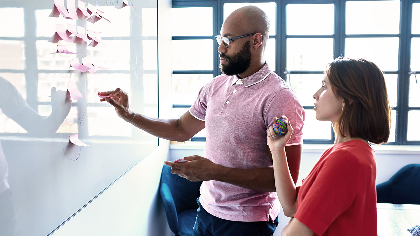 Man and woman viewing whiteboard