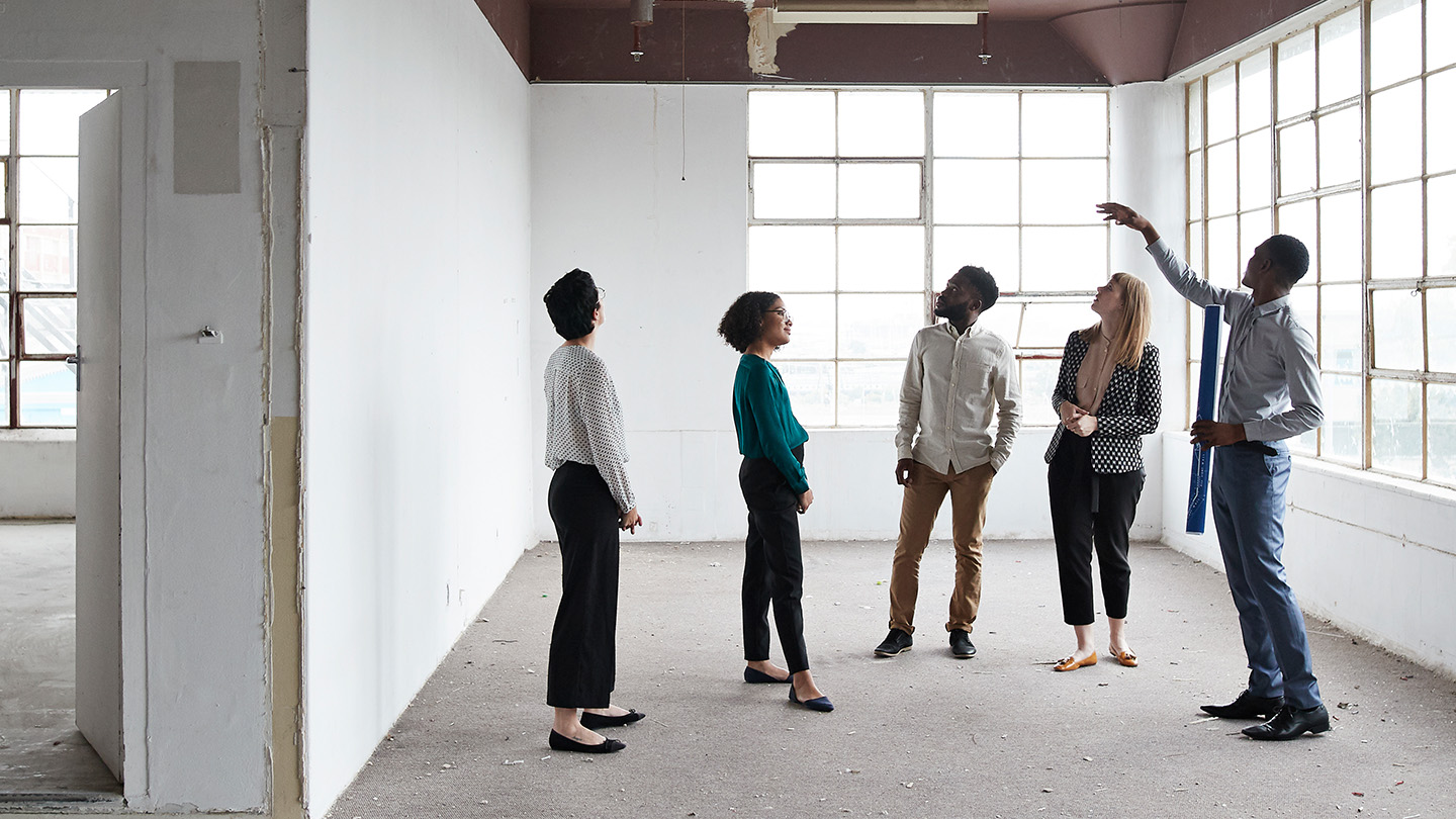 Group of people talking in a building that is under construction