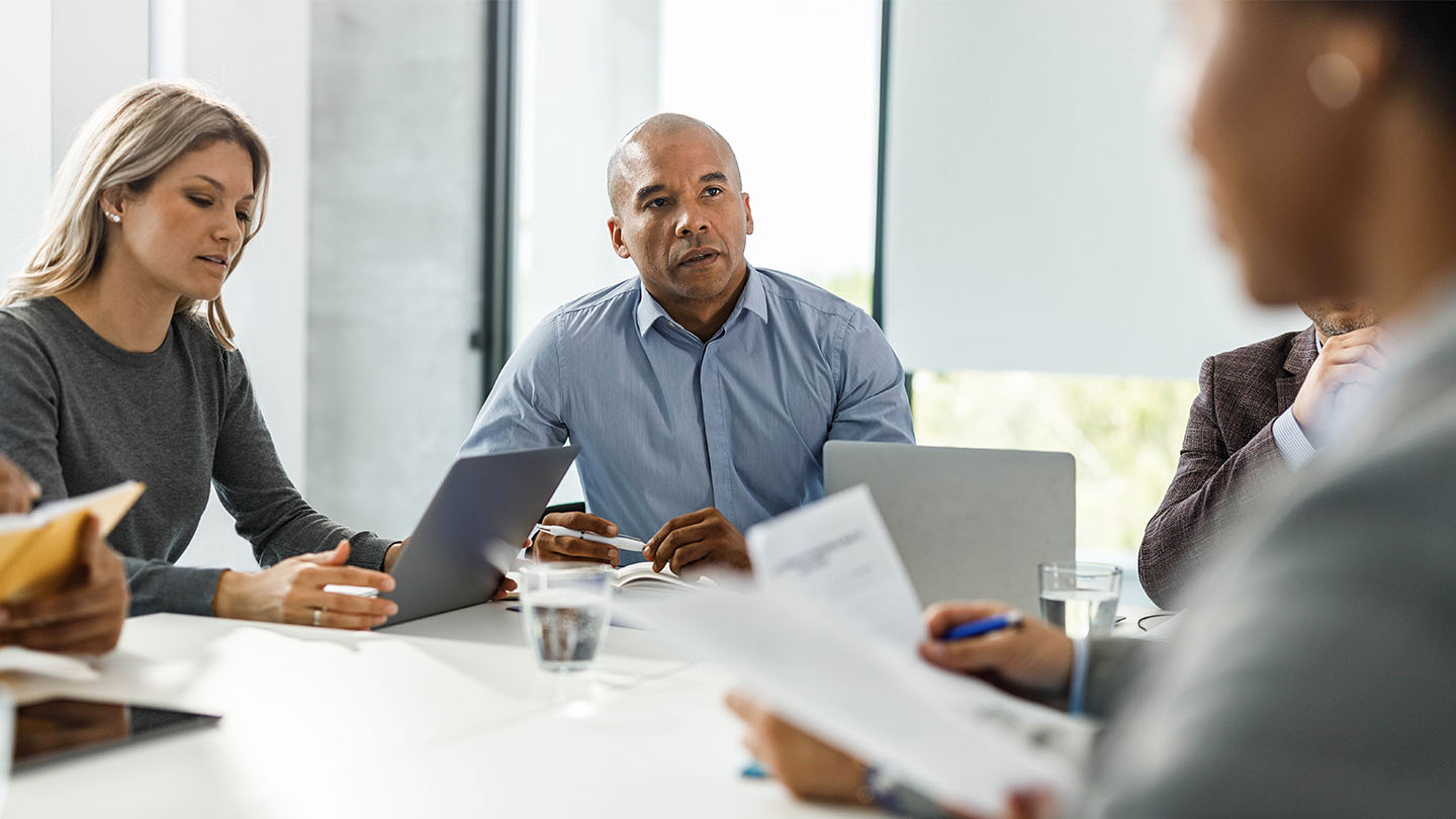 5 people in a meeting room