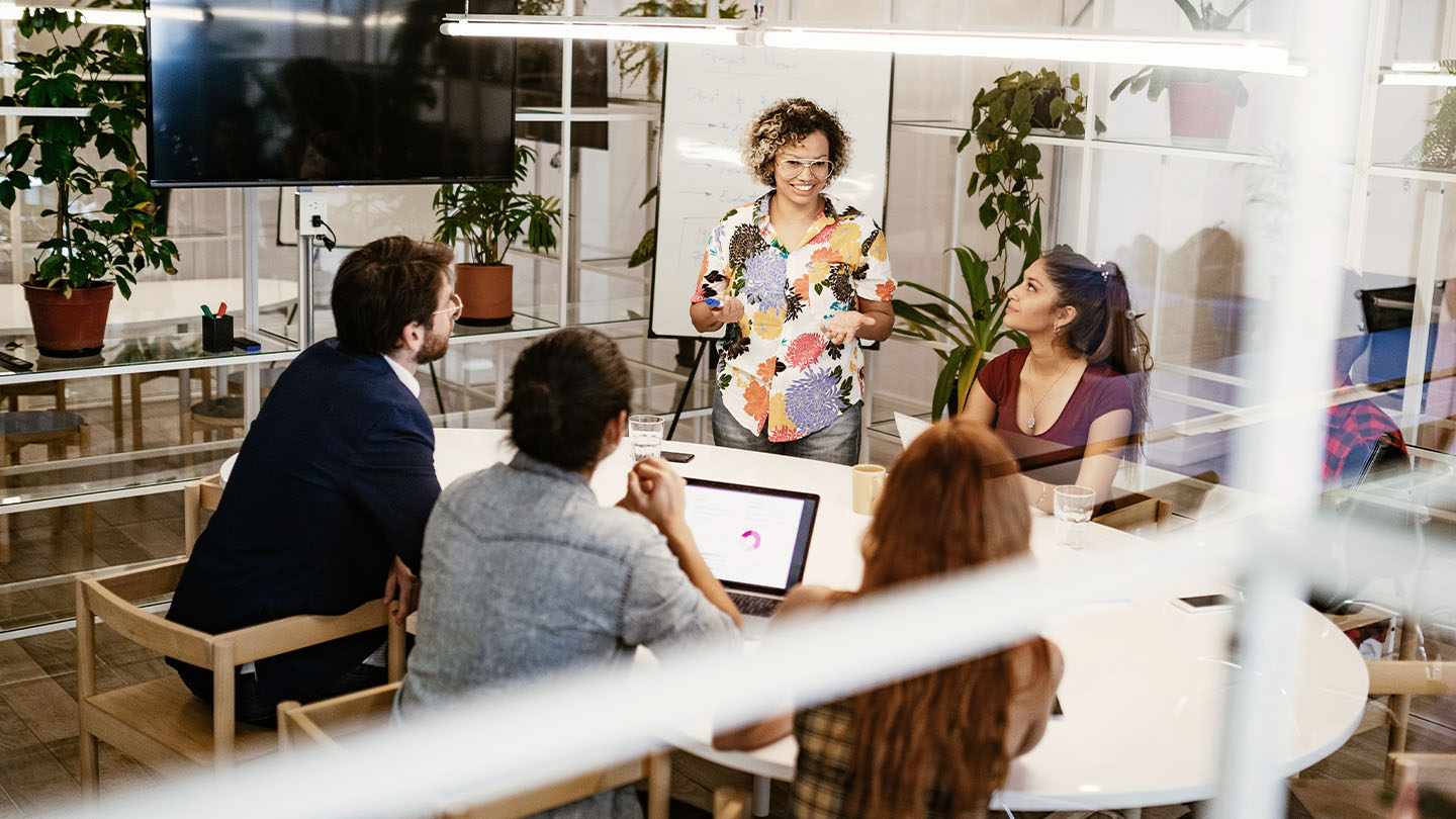 a woman giving a meeting in conference room banner