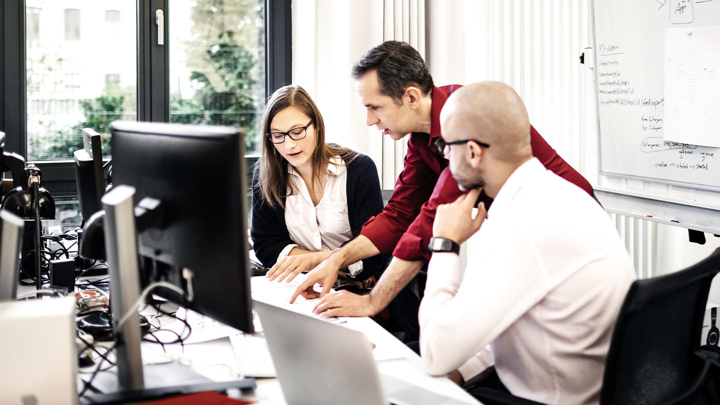 Professionals working in front of a monitor