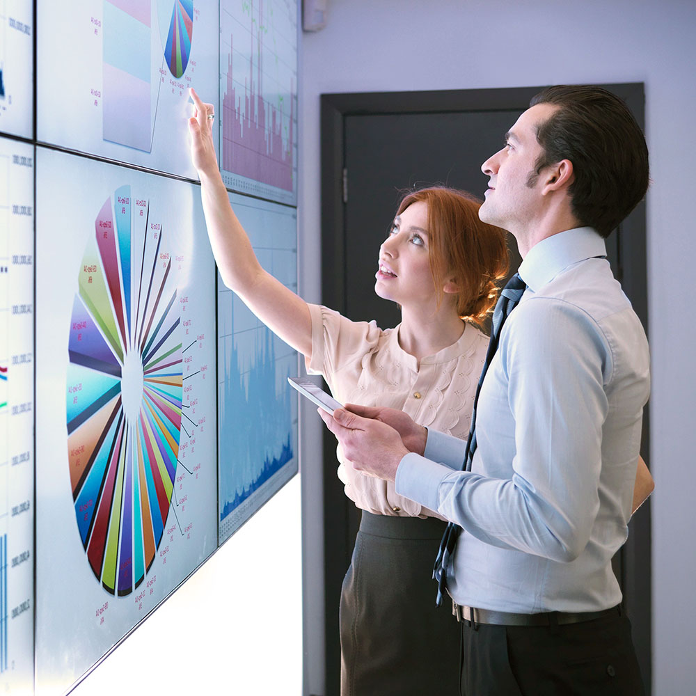 Two professionals looking at charts