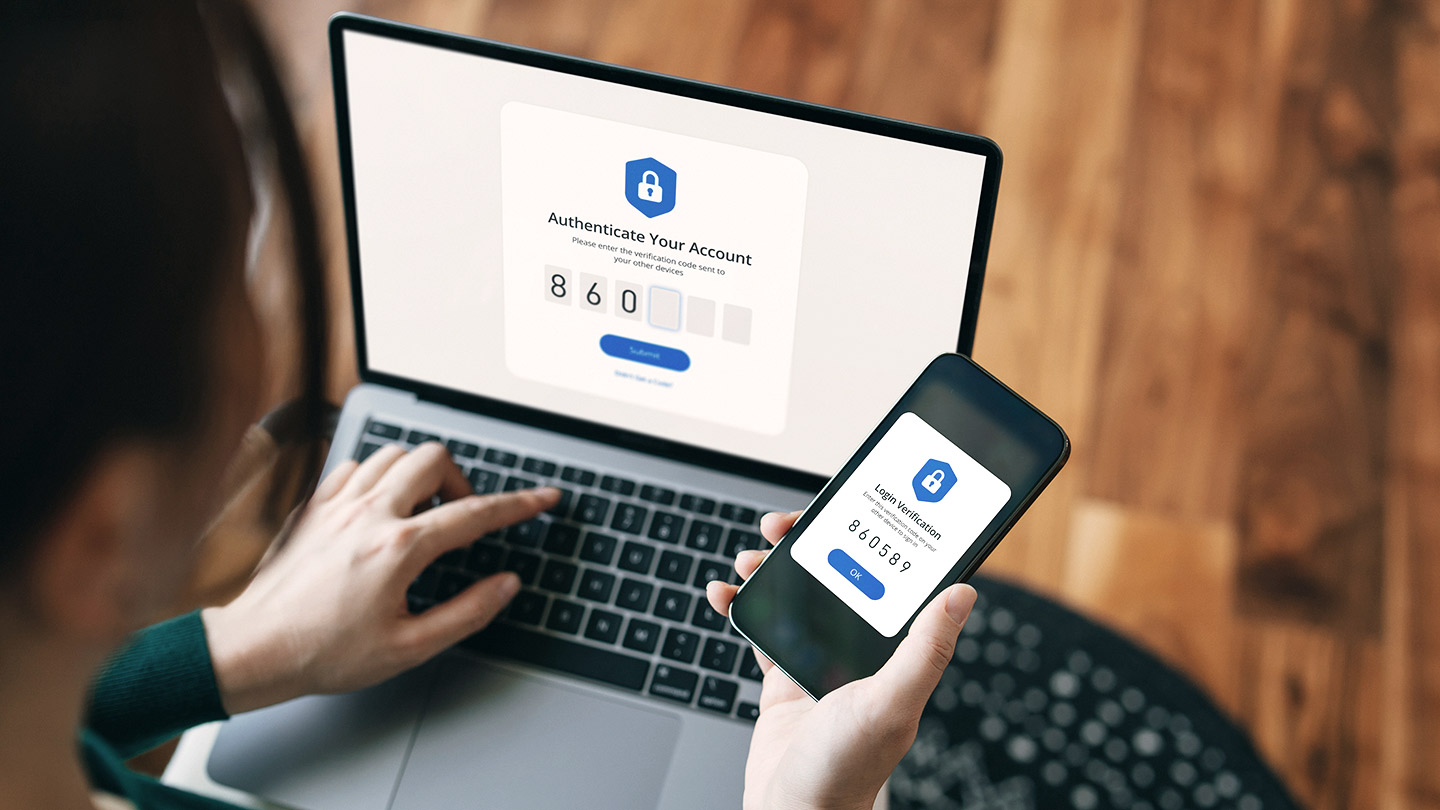 person using computer with phone