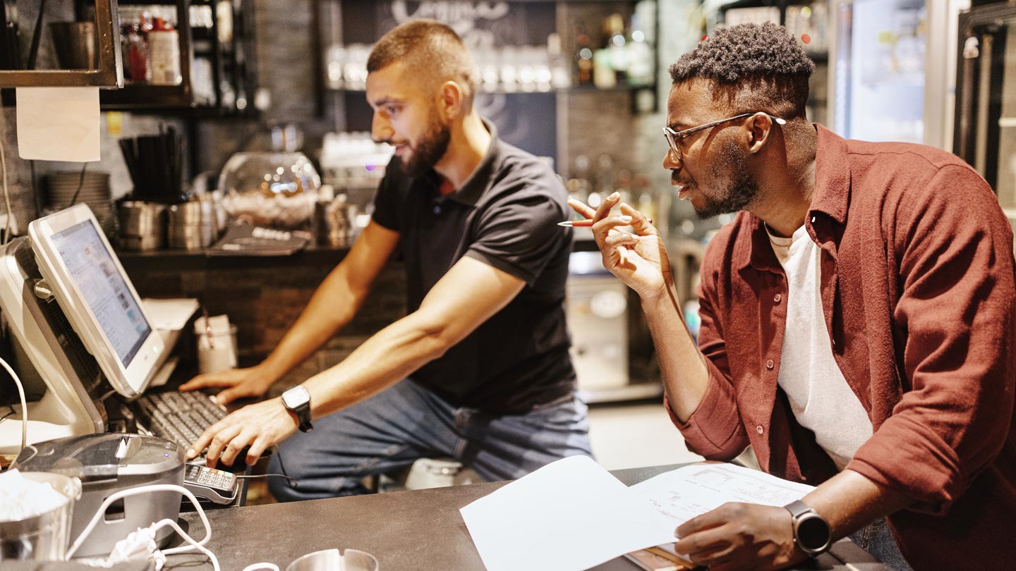 Two businessmen looking at economic data on a computer