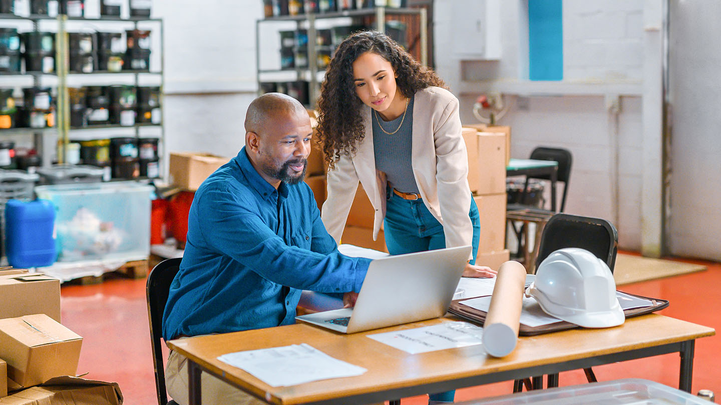 2 people looking at a laptop