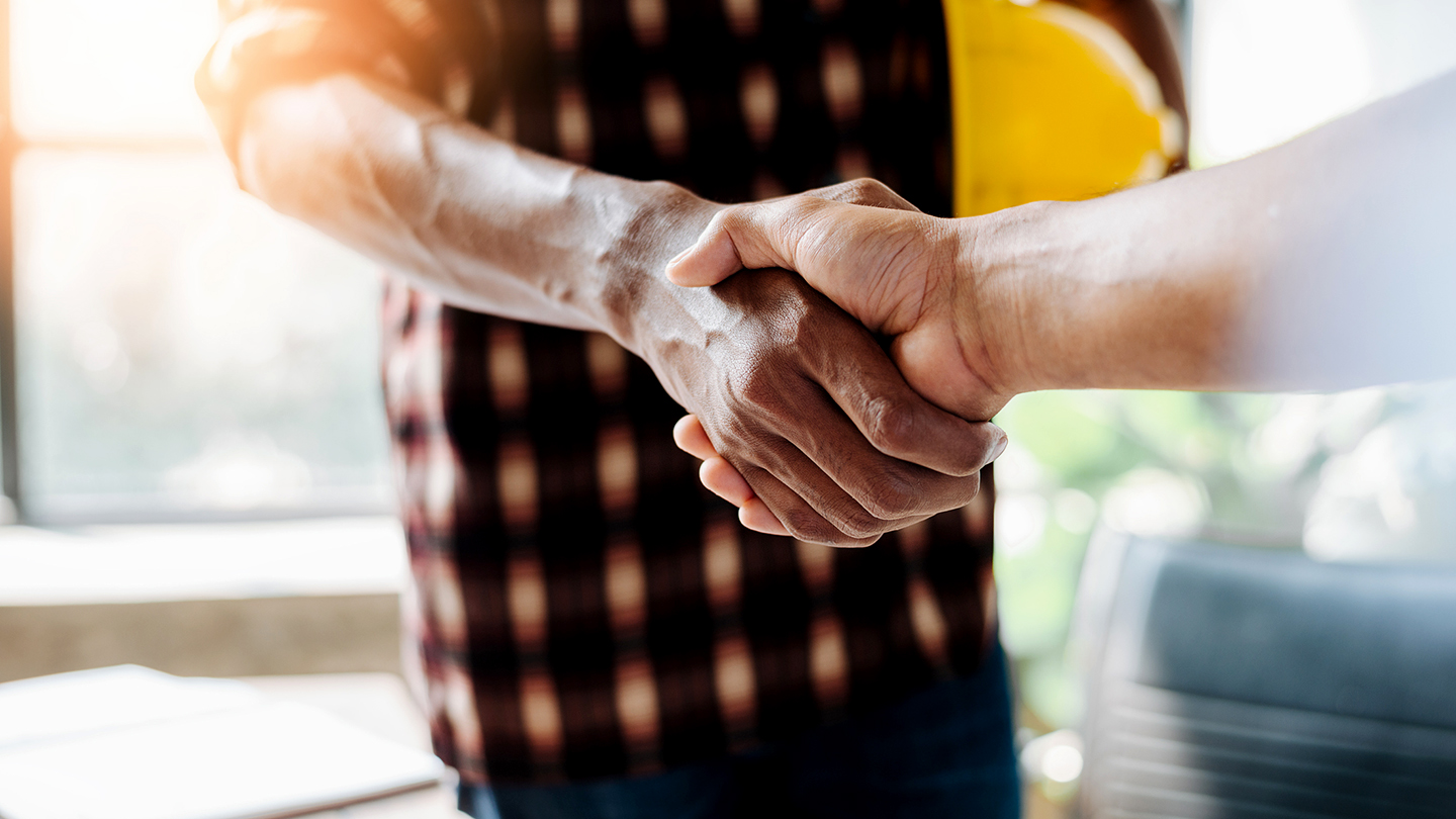 Property owner and contractor shake hands