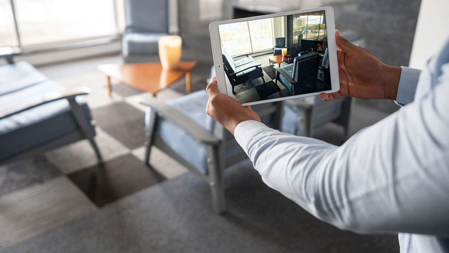 A man conducts a virtual property tour using a tablet