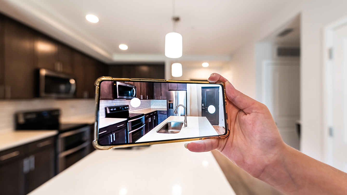 Agent uses phone to provide a video tour of an apartment