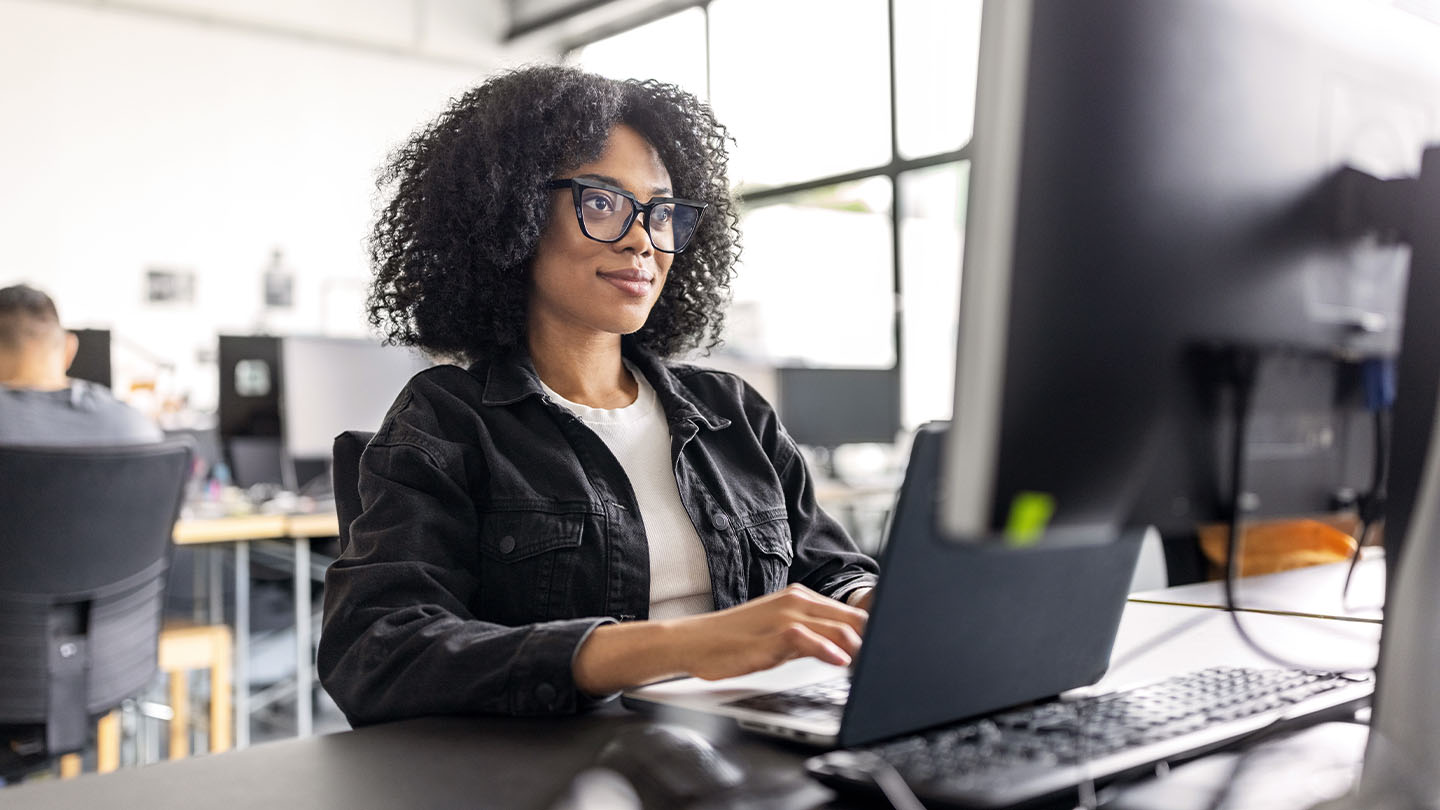 Woman using her laptop computer banner