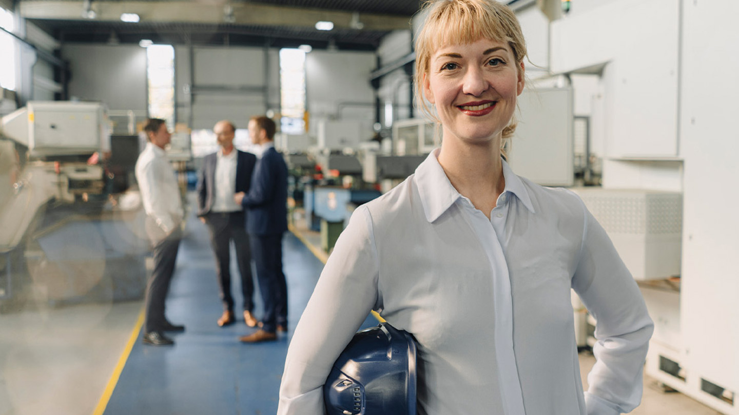 Woman smiling in industrial setting
