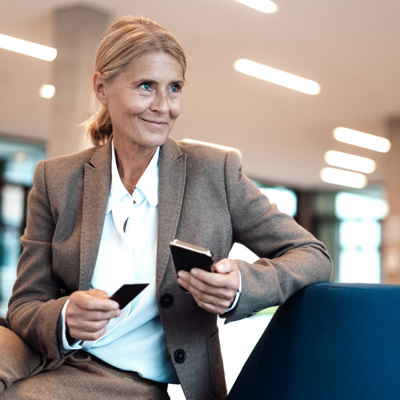 Professional holding a card and a mobile device